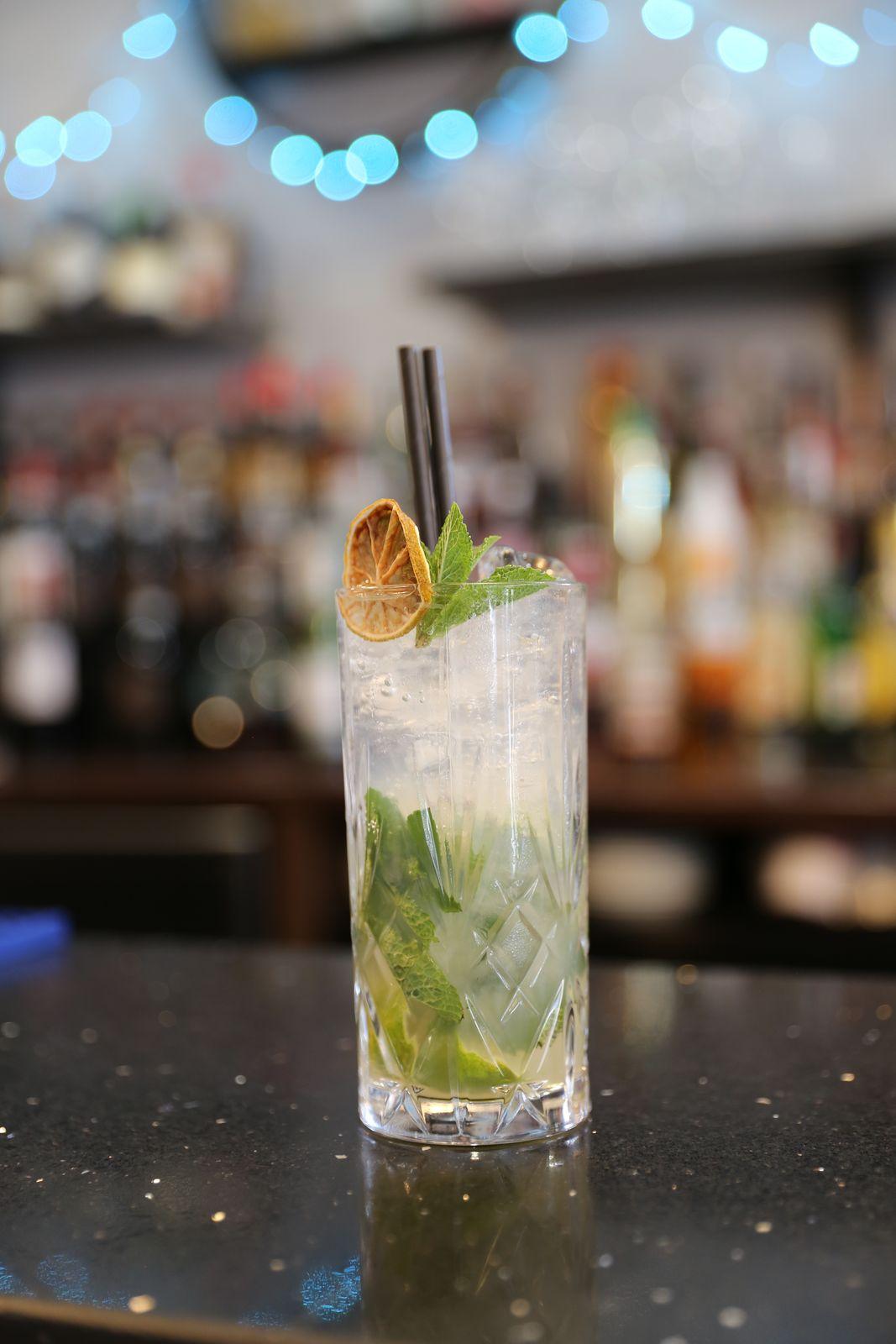 A mojito with fresh mint and dried lime at the bar