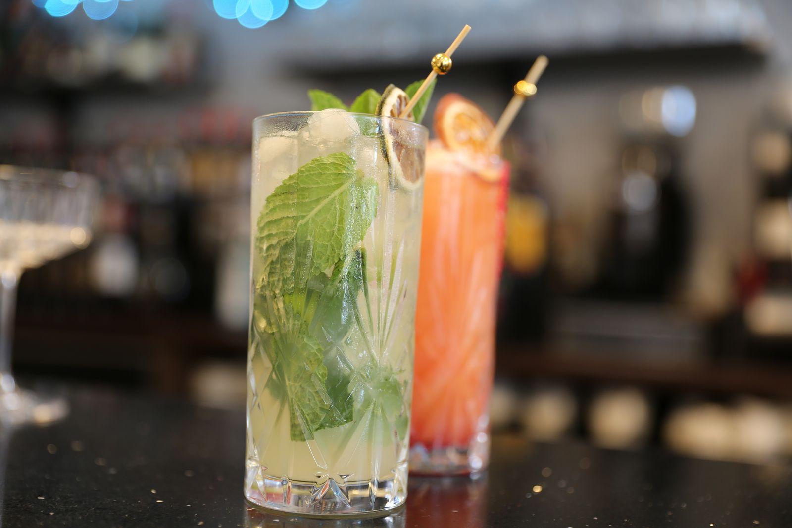 A mojito and a spritz side by side on the bar