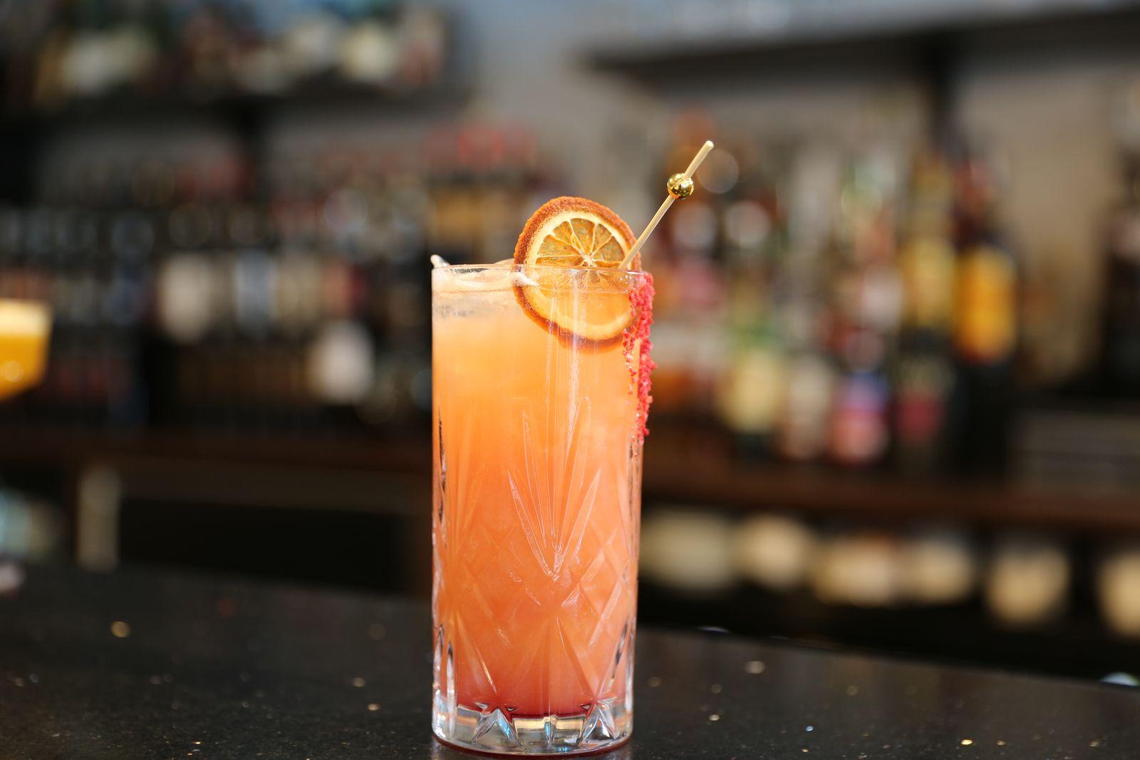 A spritz garnished with a dried orange wheel