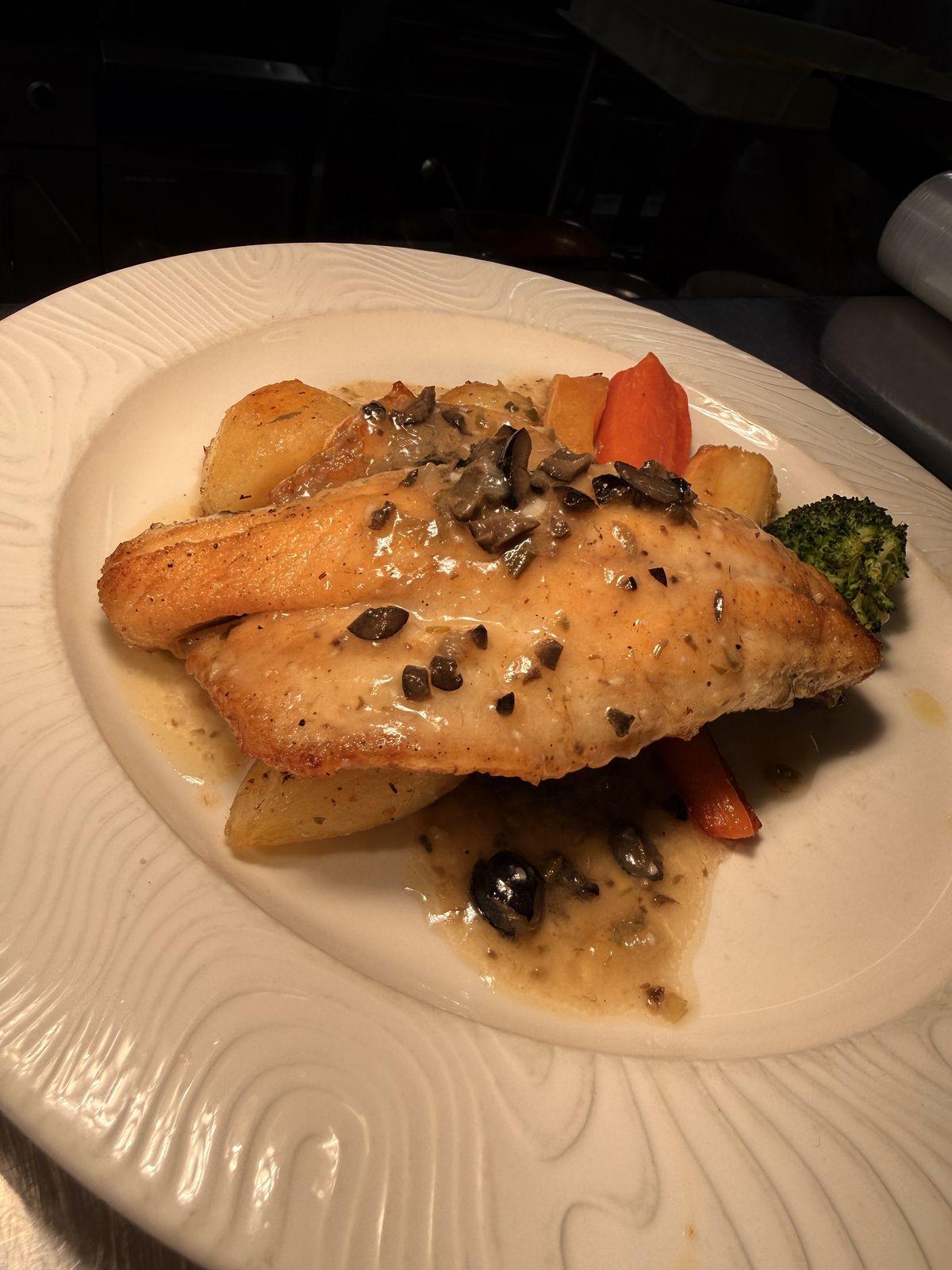 Pan-fried sea bass with olives, capers and roast potatoes