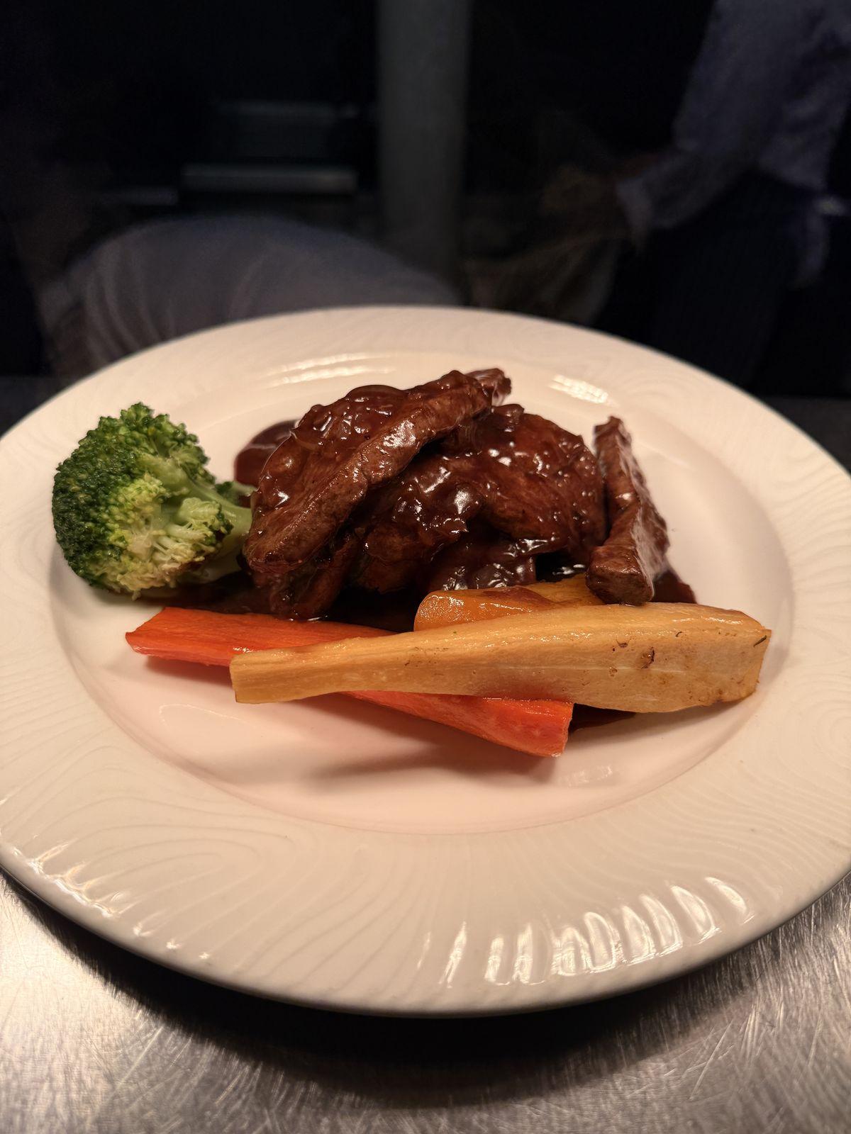 Chicken breast with a dark jus and roasted vegetables