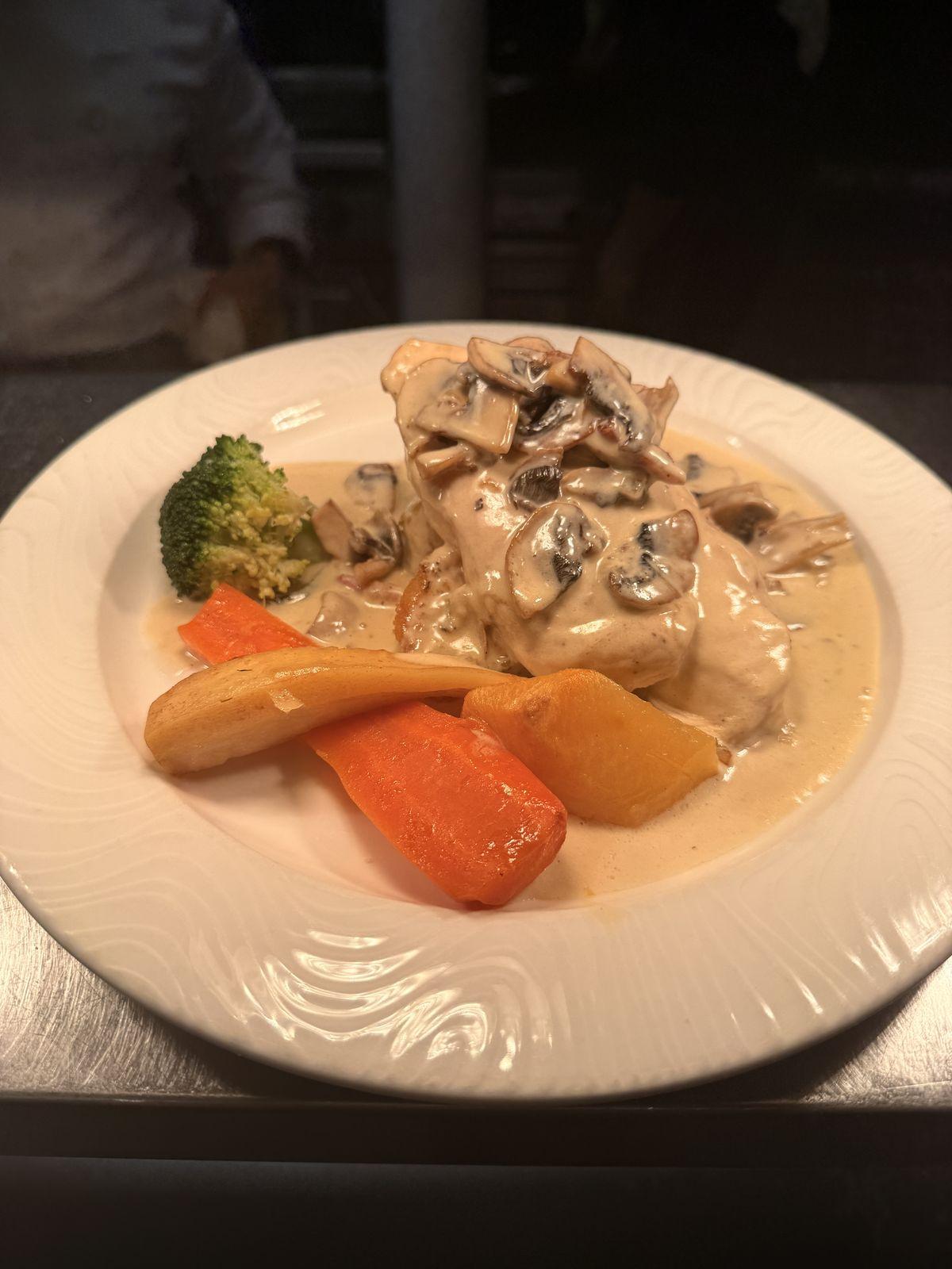 Chicken breast in mushroom cream with broccoli and carrots