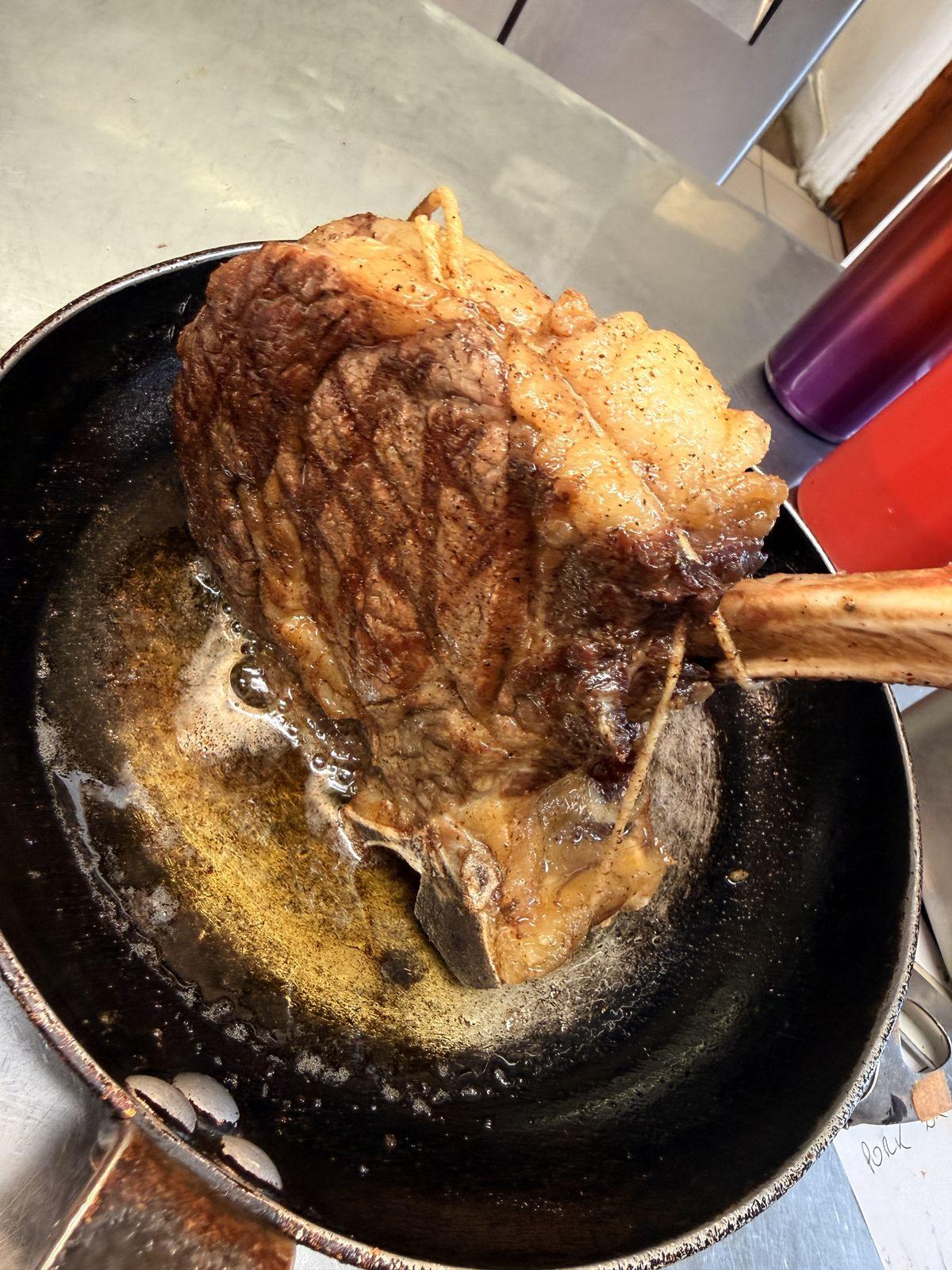 Tomahawk steak basting in butter