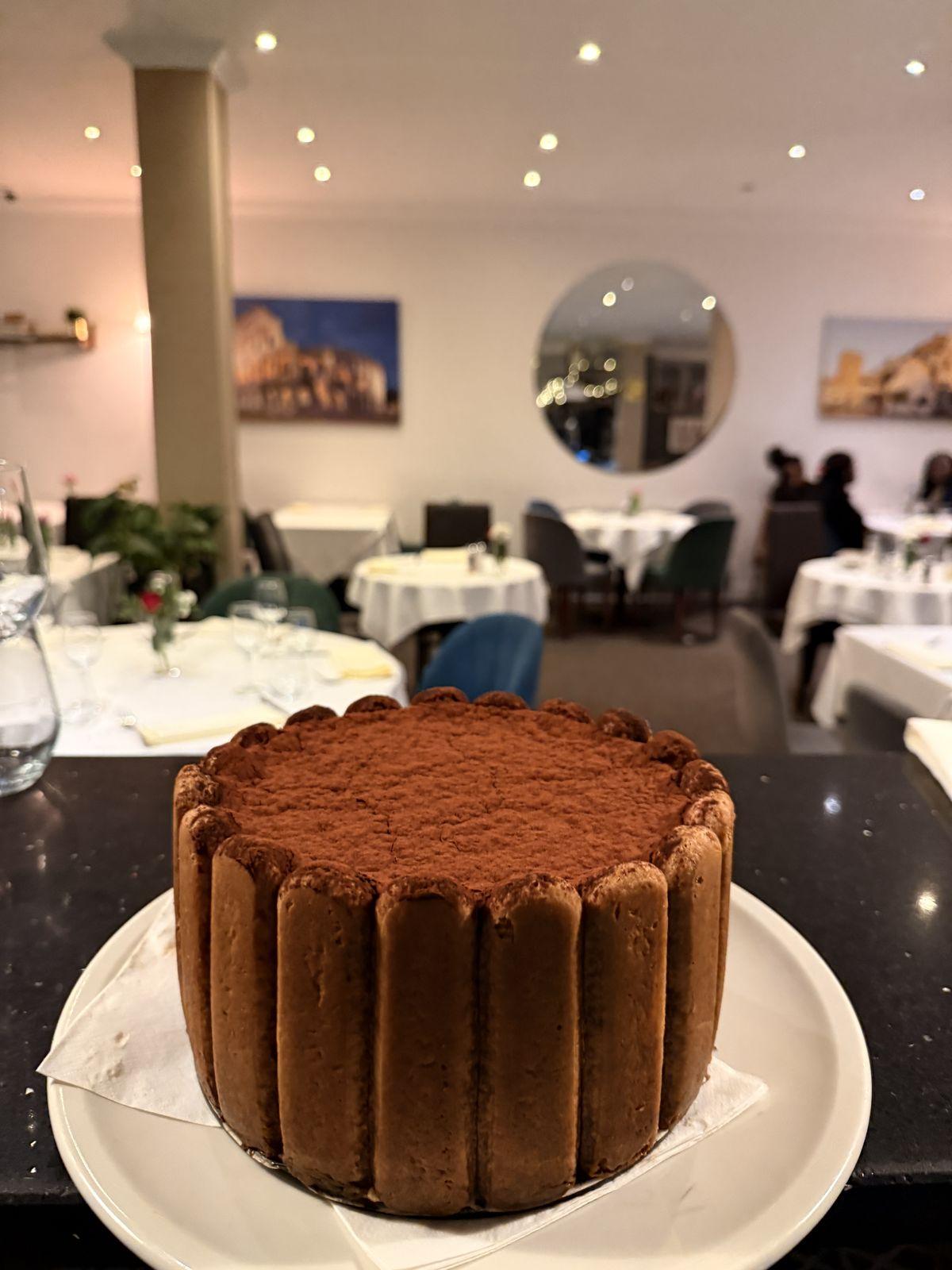 A whole tiramisù dusted with cocoa