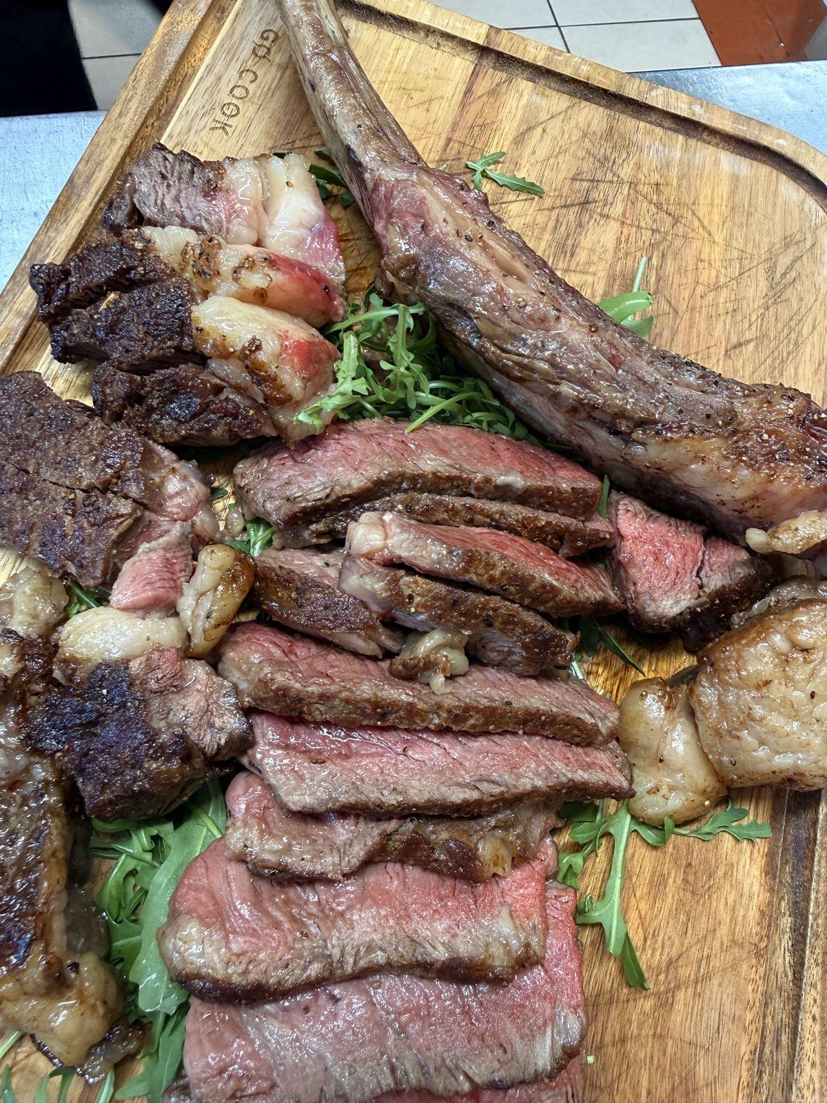 Sliced steak on rocket with roast potatoes