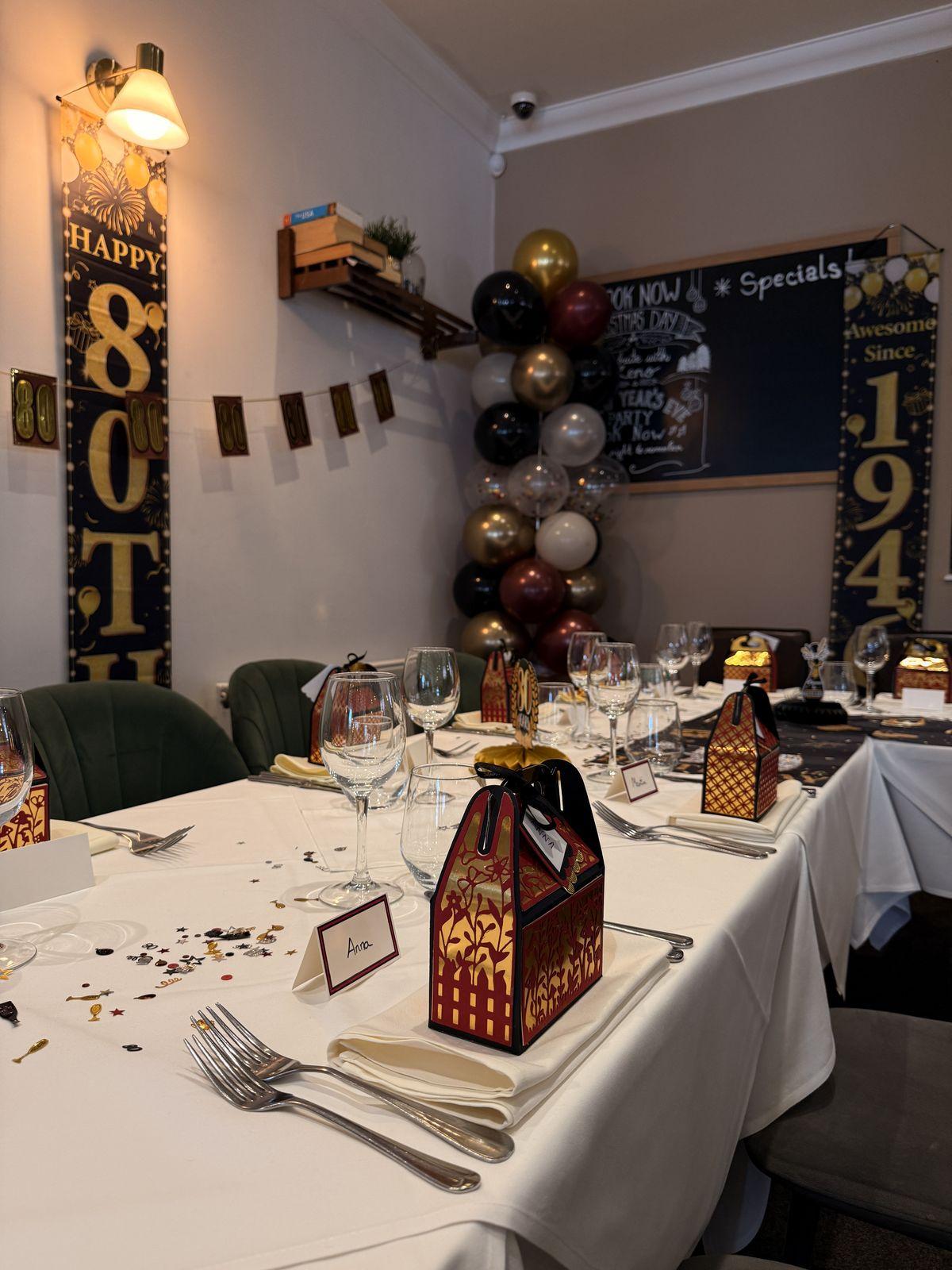 Table laid with gift boxes and birthday décor